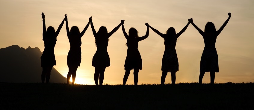 Photo of a group of women at sunset